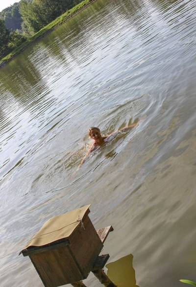 Cheerful girl jumps topless from the bungee