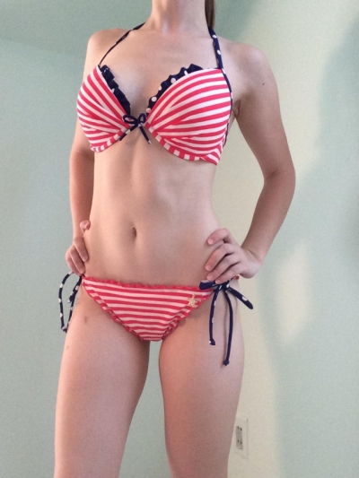 Blonde poses in a bikini getting naked and showing off her slim figure
