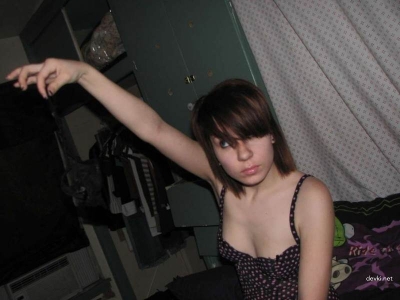 Young woman posing nude on bed at home