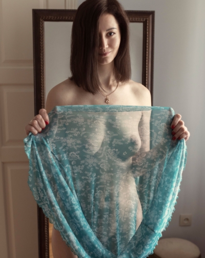 Sexy woman trying on a summer dress on her naked body