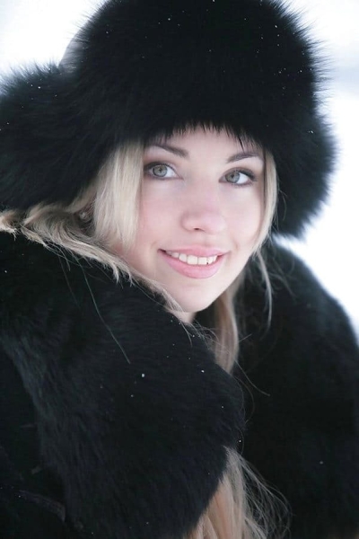 A girl walks in a coat over her naked body