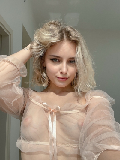 Young sexy blonde takes naked photos of her slender body